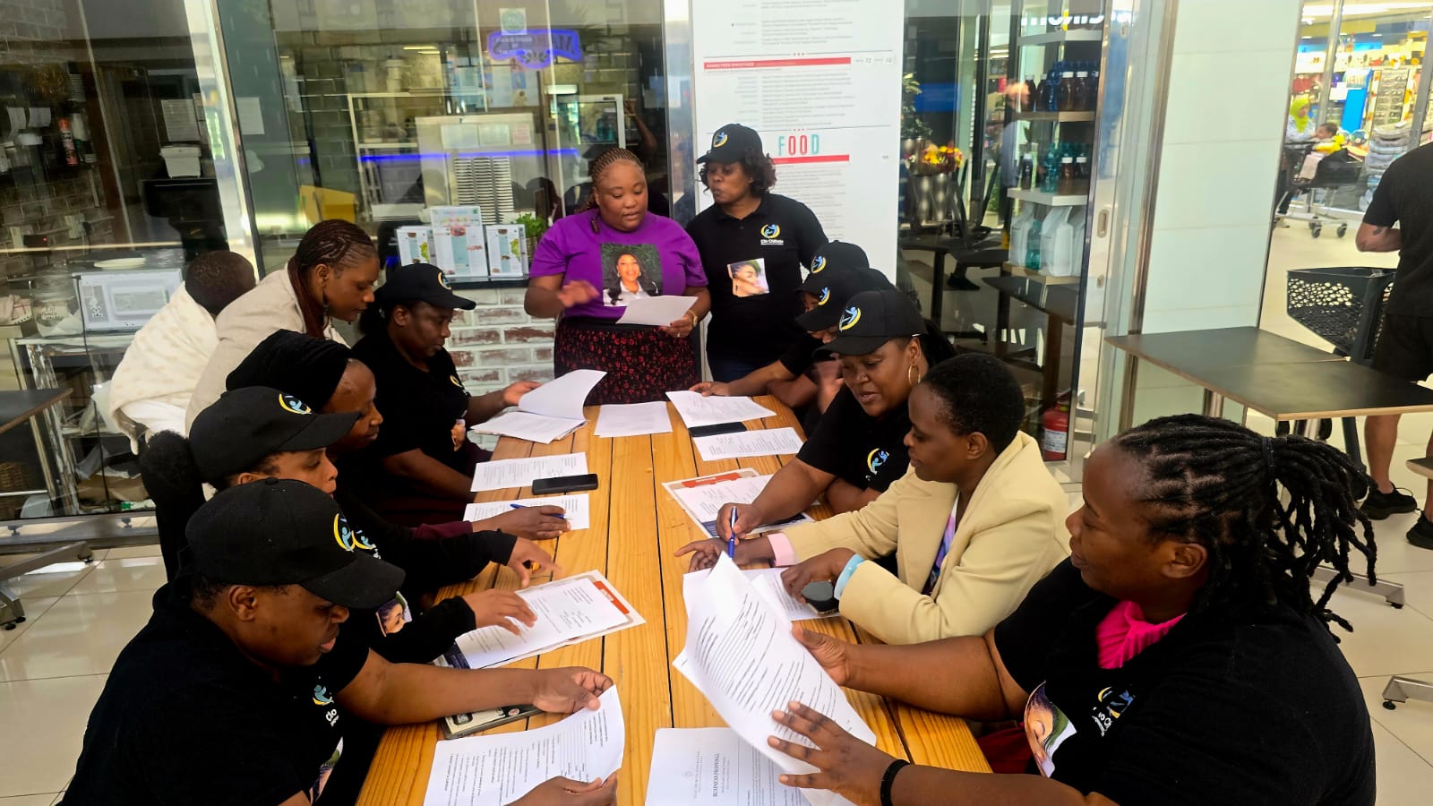 Women reviewing programme documents at a training session
